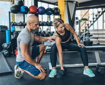 A coach guiding a gym exercise